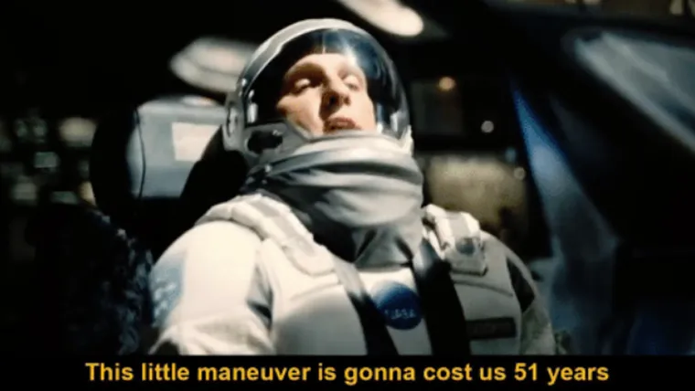 Matthew McConaughey as Cooper in a spacesuit in the cockpit, looking worried, with a subtitle