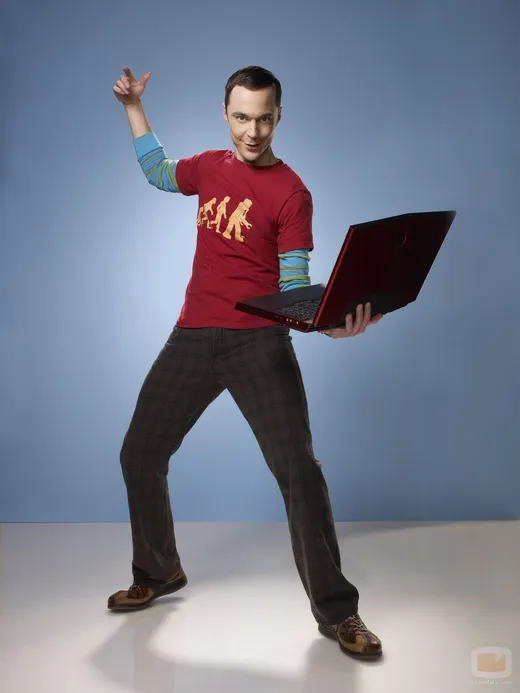 Sheldon Cooper in a red superhero T-shirt, posing triumphantly