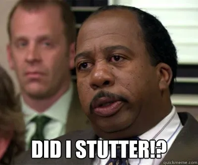 Stanley Hudson in a meeting, looking furious, with the caption "Did I stutter!?"