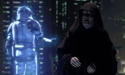 A blue hologram of Darth Sidious in a hood, facing a clone commander