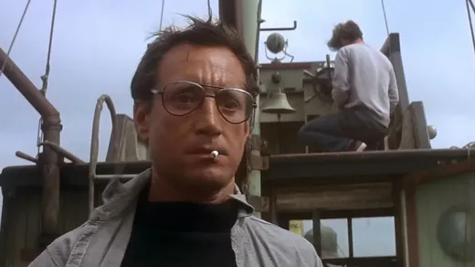 Chief Brody on the back of a fishing boat, backing away in shock