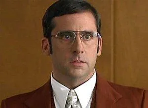 Steve Carell as Brick Tamland in a brown suit, looking vacant