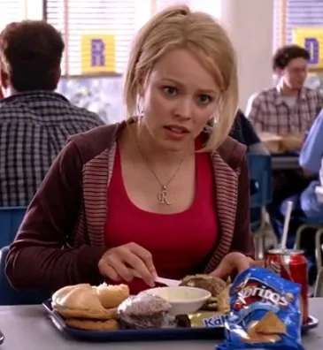 Regina George at a cafeteria table, asking a question