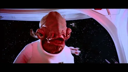 Admiral Ackbar, a fish-like alien in a white uniform, on the bridge of his ship