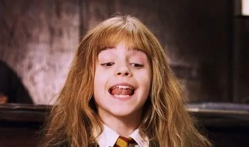 Young Hermione Granger in school robes, speaking with a superior expression