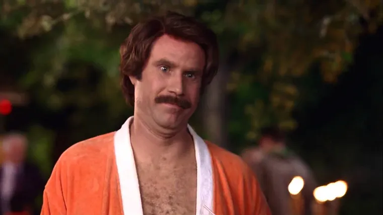 Ron Burgundy in a suit with a moustache and blow-dried hair, looking smug