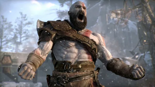 Kratos, a bearded, tattooed warrior, standing next to his young son