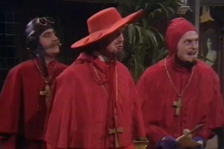 Three men dressed as cardinals in red robes bursting into a room