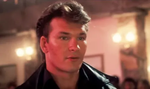 Patrick Swayze as Johnny Castle in black, speaking firmly