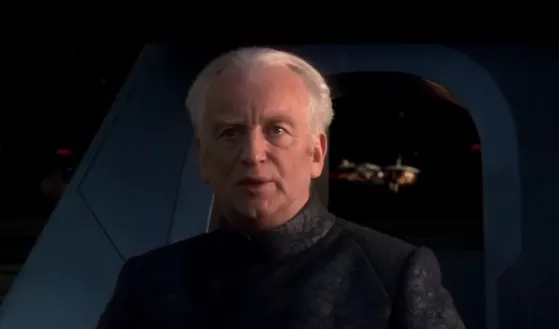 Chancellor Palpatine in a dark robe, looking up with a serious expression