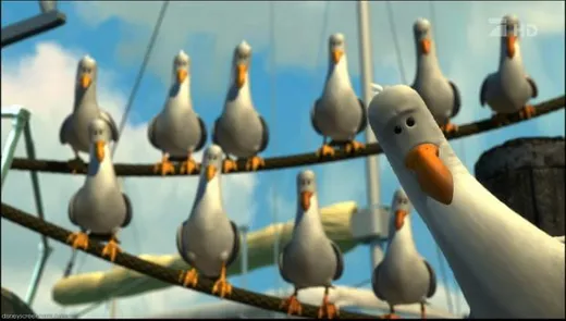 A row of seagulls on a dock, all with beaks open