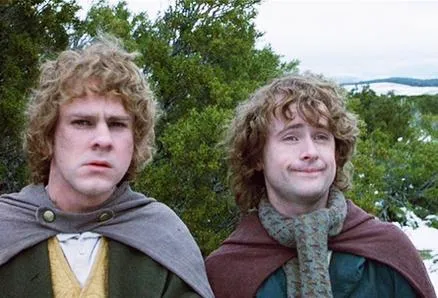 Merry and Pippin, two hobbits, looking puzzled outdoors