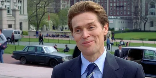 Willem Dafoe as Norman Osborn, in a suit, smiling proudly