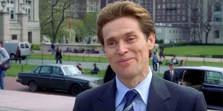 Willem Dafoe as Norman Osborn, in a suit, smiling proudly