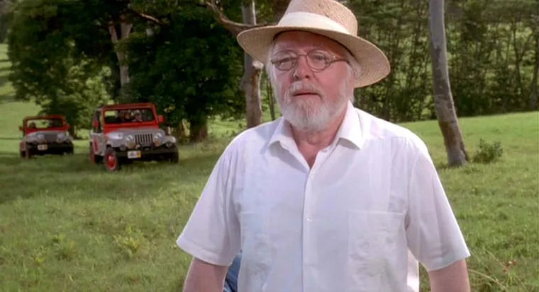John Hammond, an old man with a white beard and hat, smiling proudly