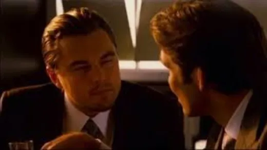 Leonardo DiCaprio as Cobb, seen from the side, speaking seriously