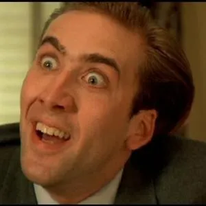 Nicolas Cage with wide eyes and a big exaggerated grin