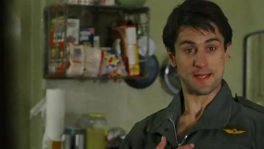Robert De Niro in a military jacket, staring intensely